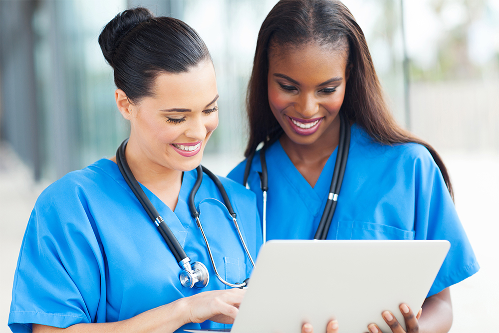 Two nurses using a laptop